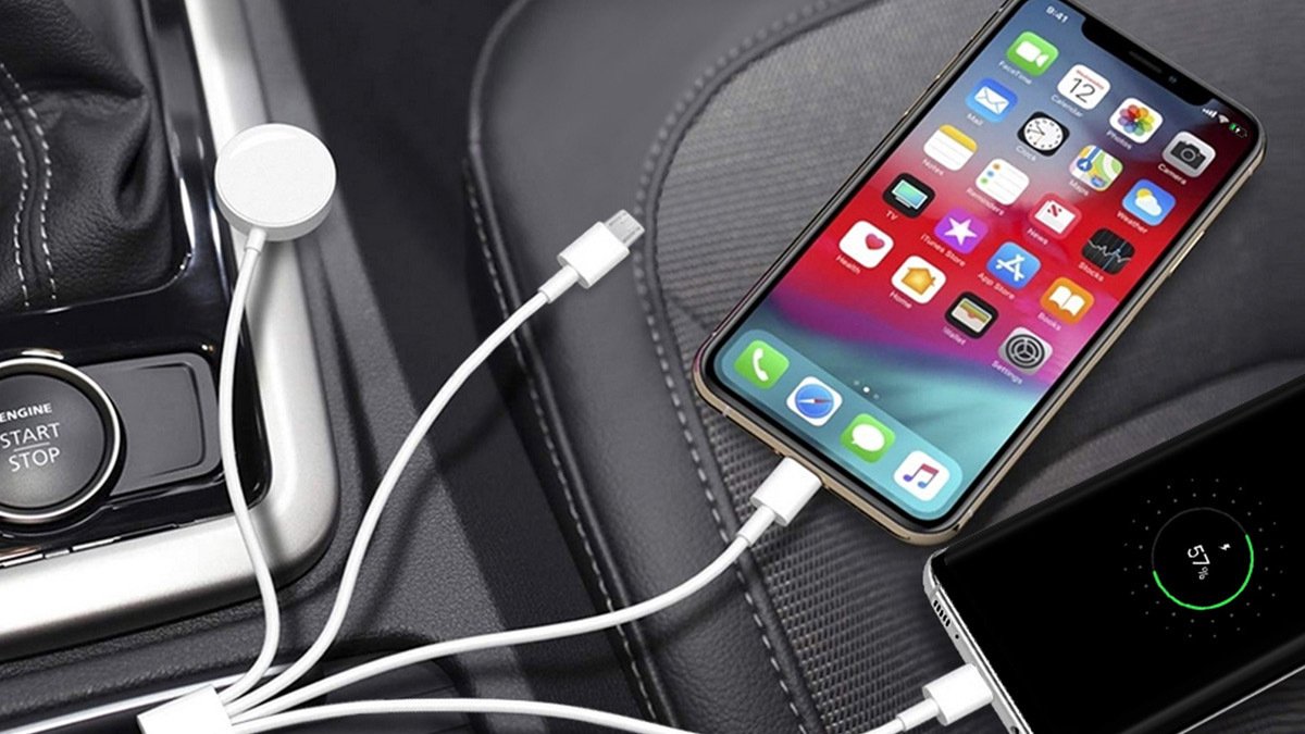 Two phones charging on four-corded white charger