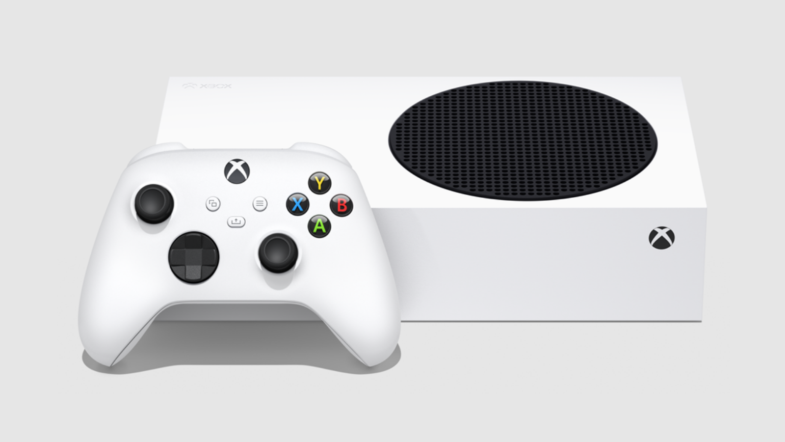 an xbox series s lying on its side next to an xbox wireless controller