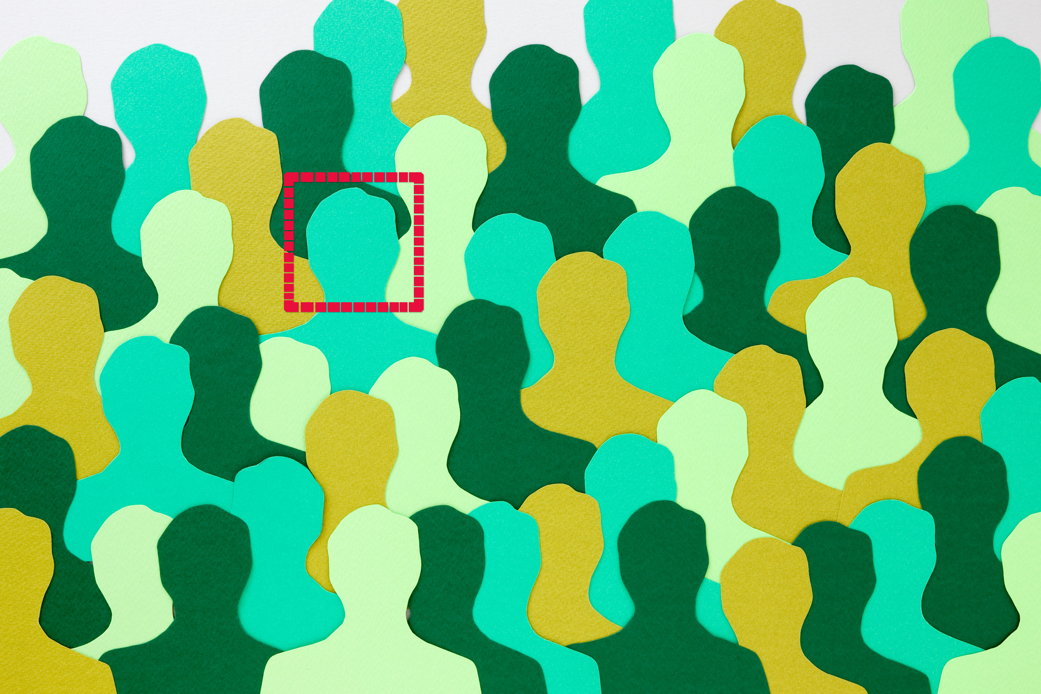 Paper cutouts in the shape of people, with a box around one of the heads.