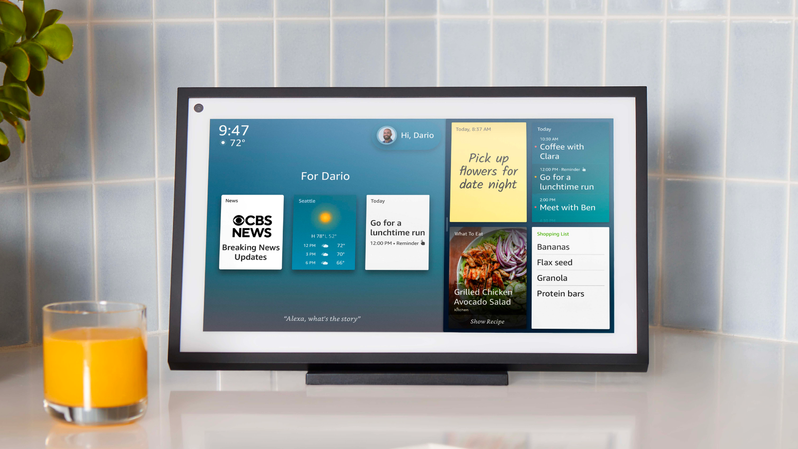 an echo show 15 sitting on a counter next to a yellow candle in front of a blue tile wall