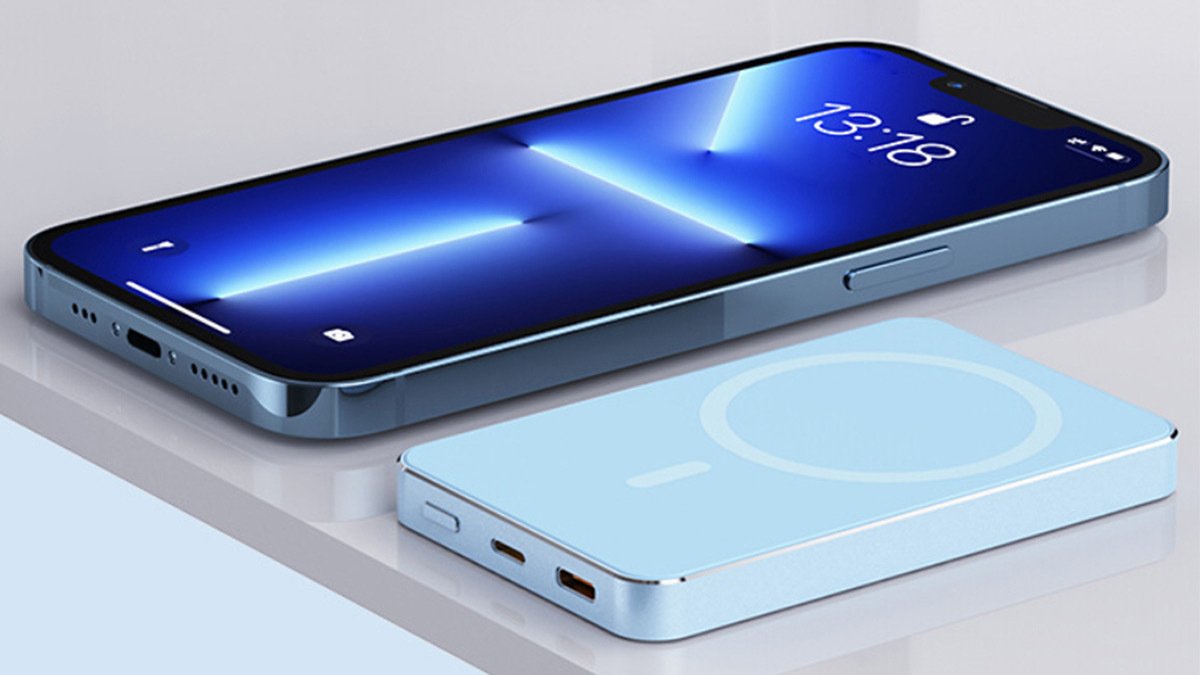 Phone with blue lockscreen next to light blue wireless charger
