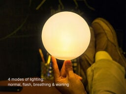 Hand balancing yellow glowing ball