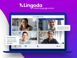 Four people smiling on video call on a laptop screen