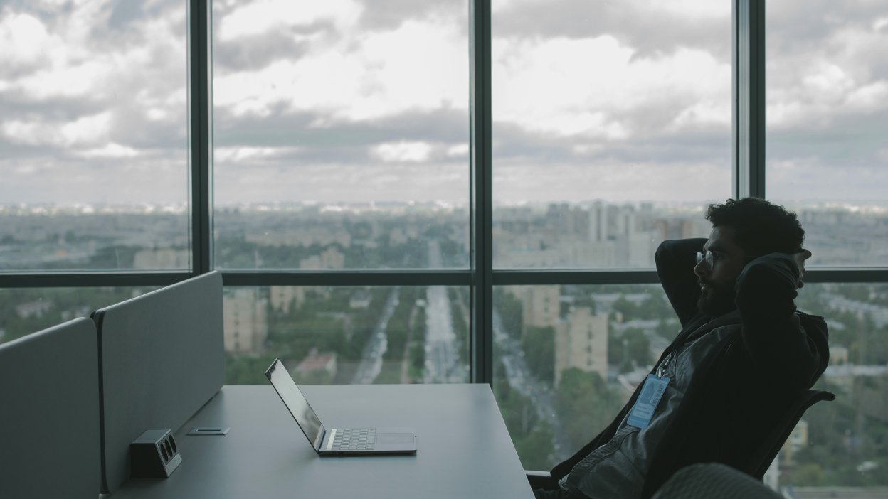 Man looking at laptop in office