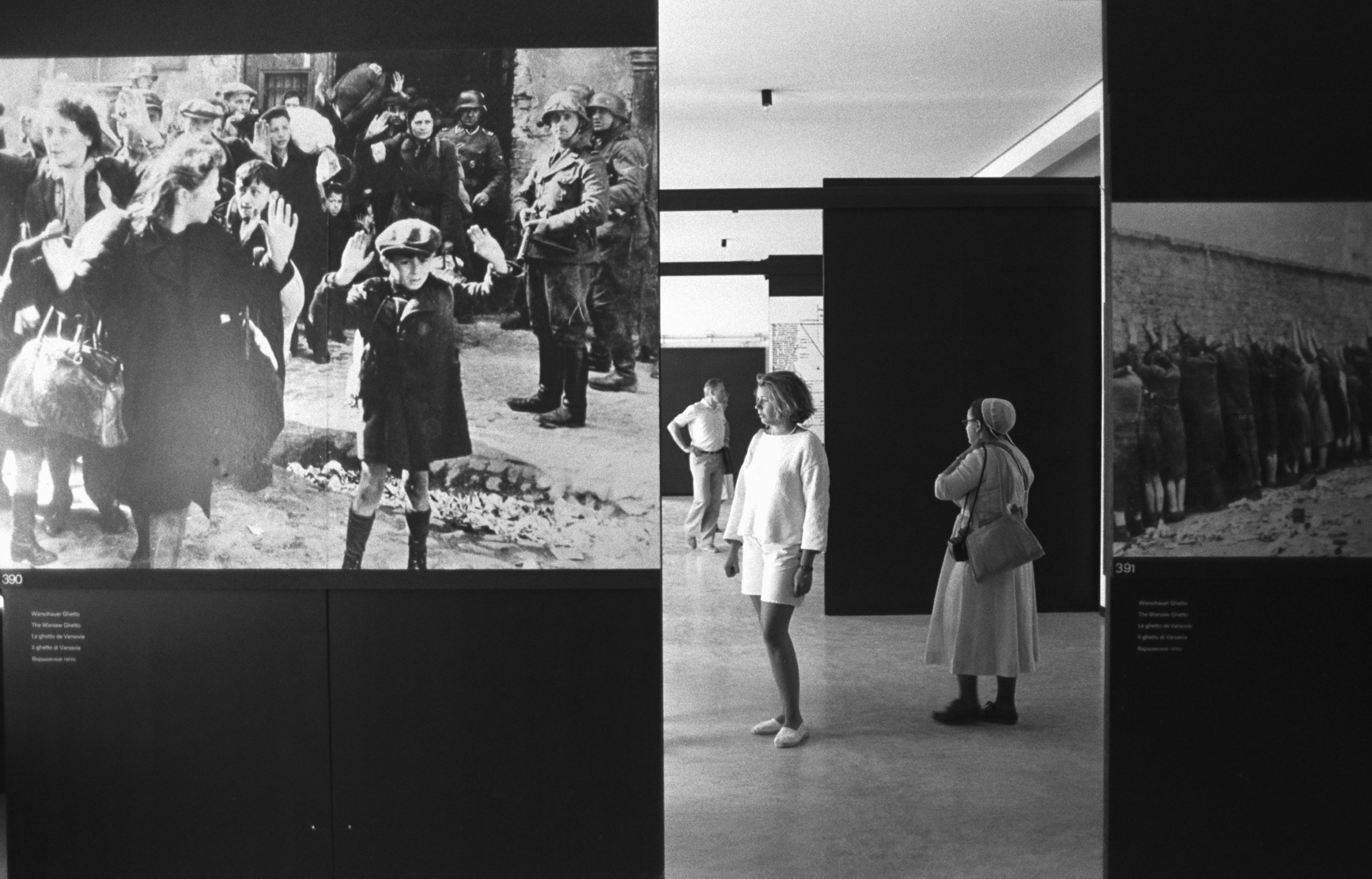 Visitors Looking at Holocaust Photographs in Concentration Camp - stock photo