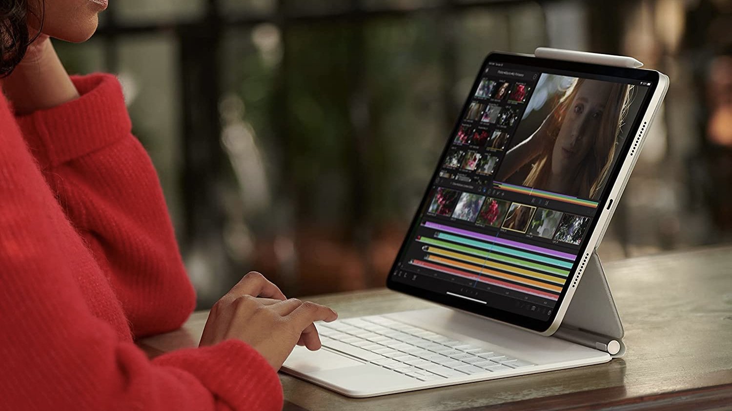 person working at a table on an ipad pro