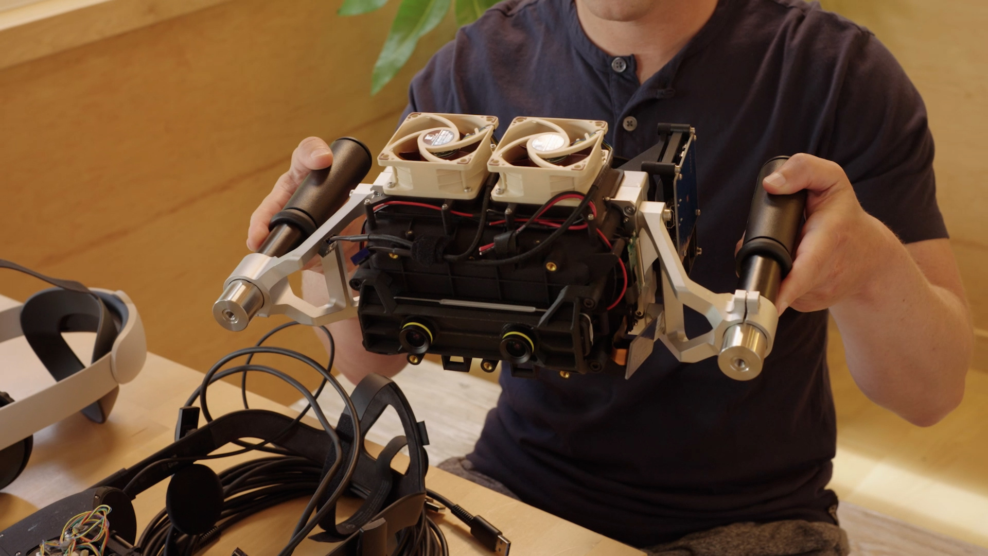 Zuckerberg holds a prototype of the Starburst in his hands. It's large and clunky, with two fans on top for cooling.