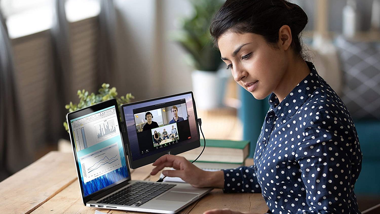 Person using laptop with external monitor attached