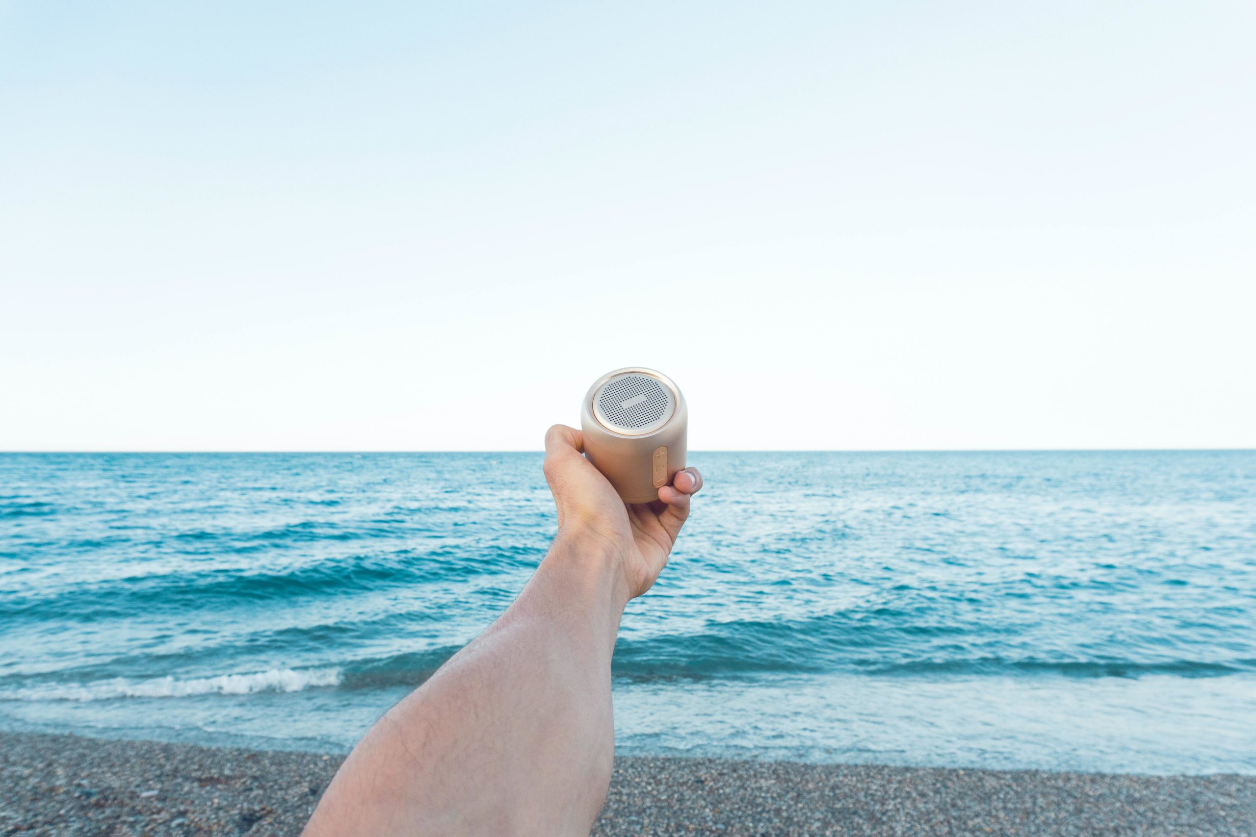 Speaker held in front of sea