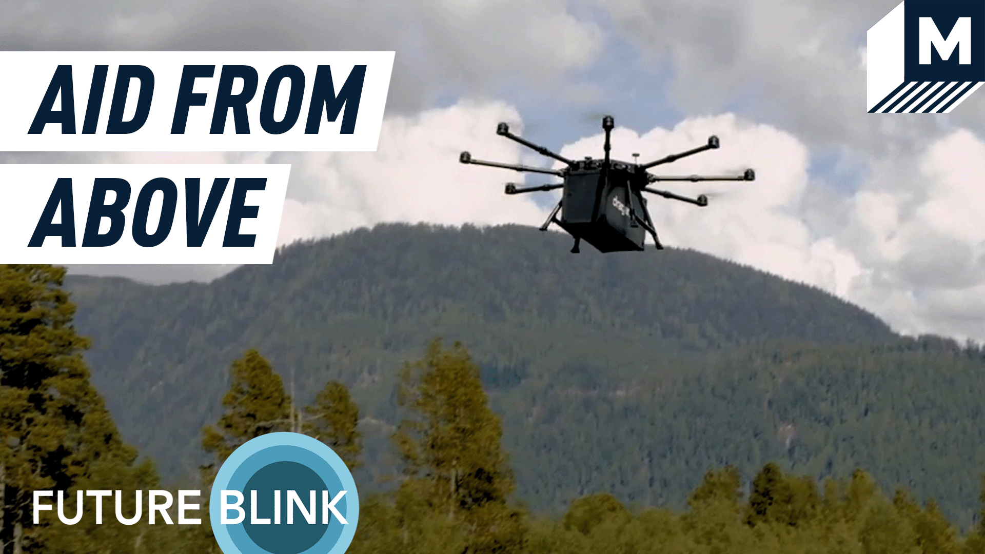 A Draganfly Innovations drone hovering in front of a backdrop of green mountains