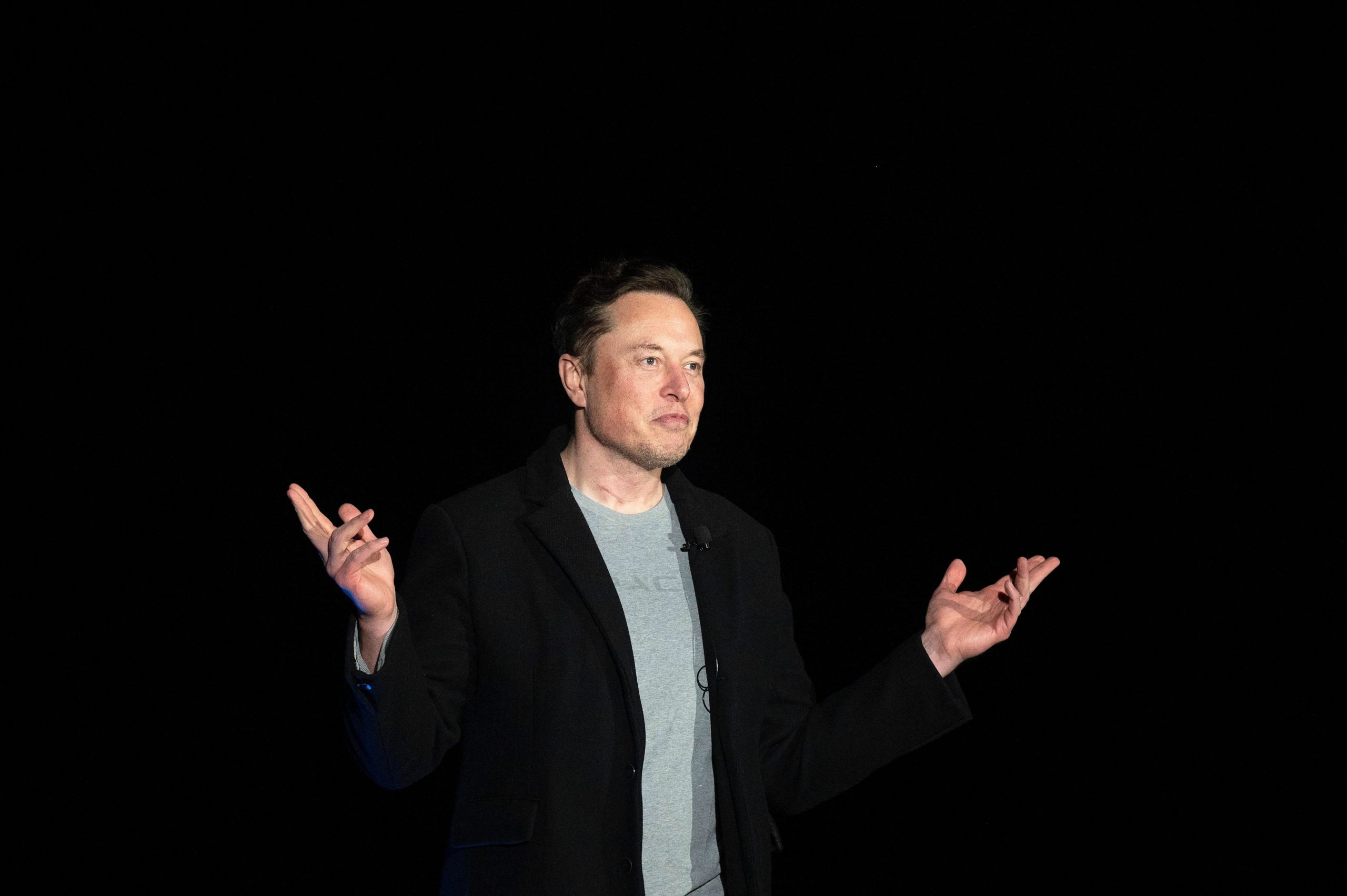 Elon Musk against a dark backdrop