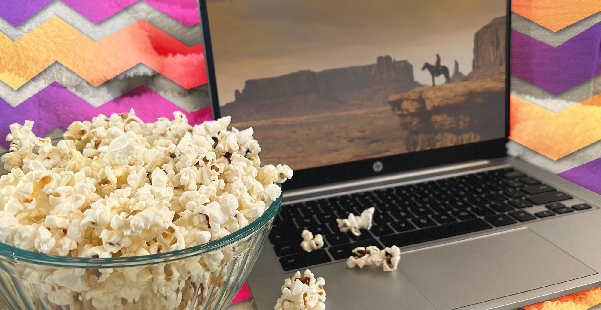 laptop with popcorn beside it