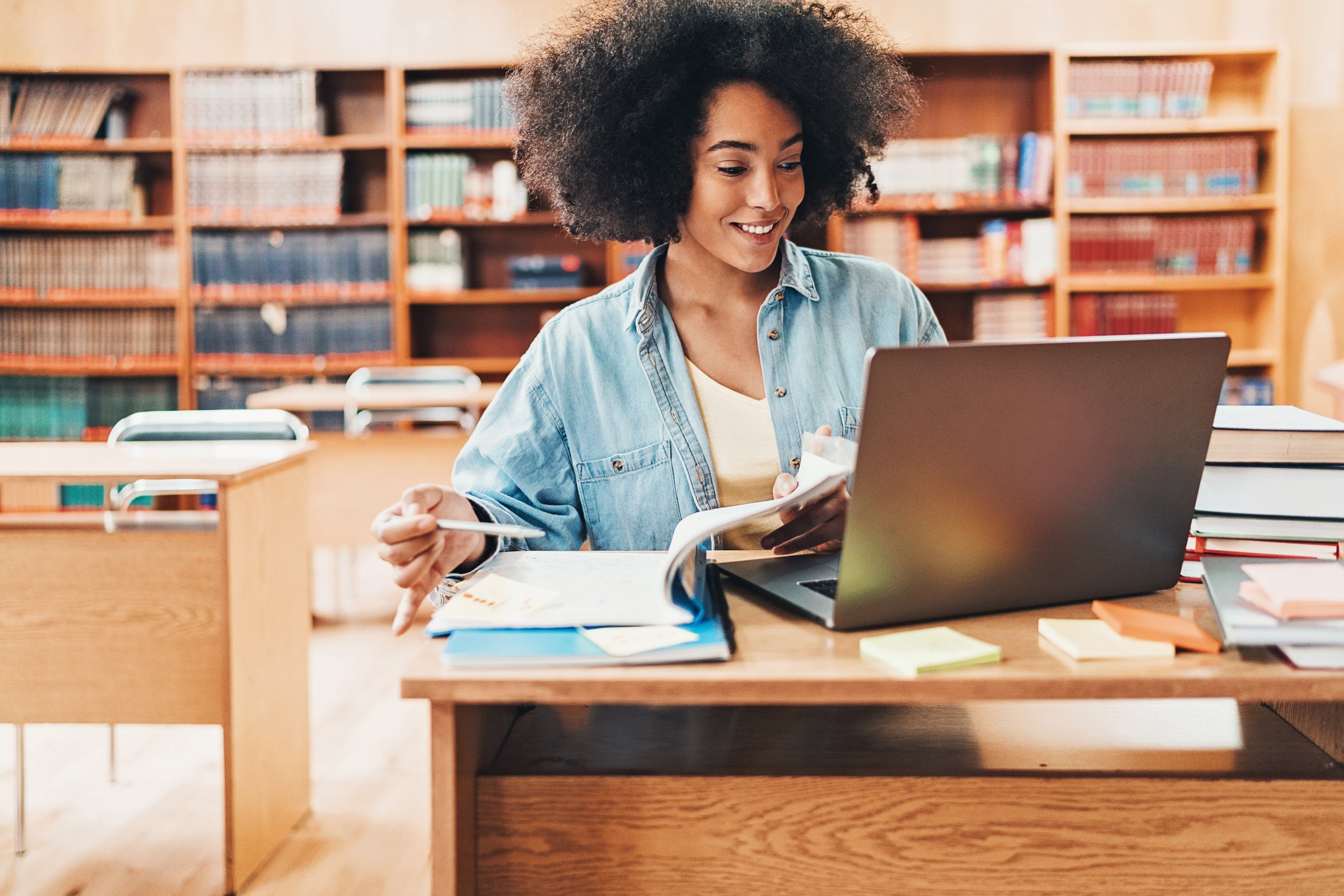 woman studying on laptop in library