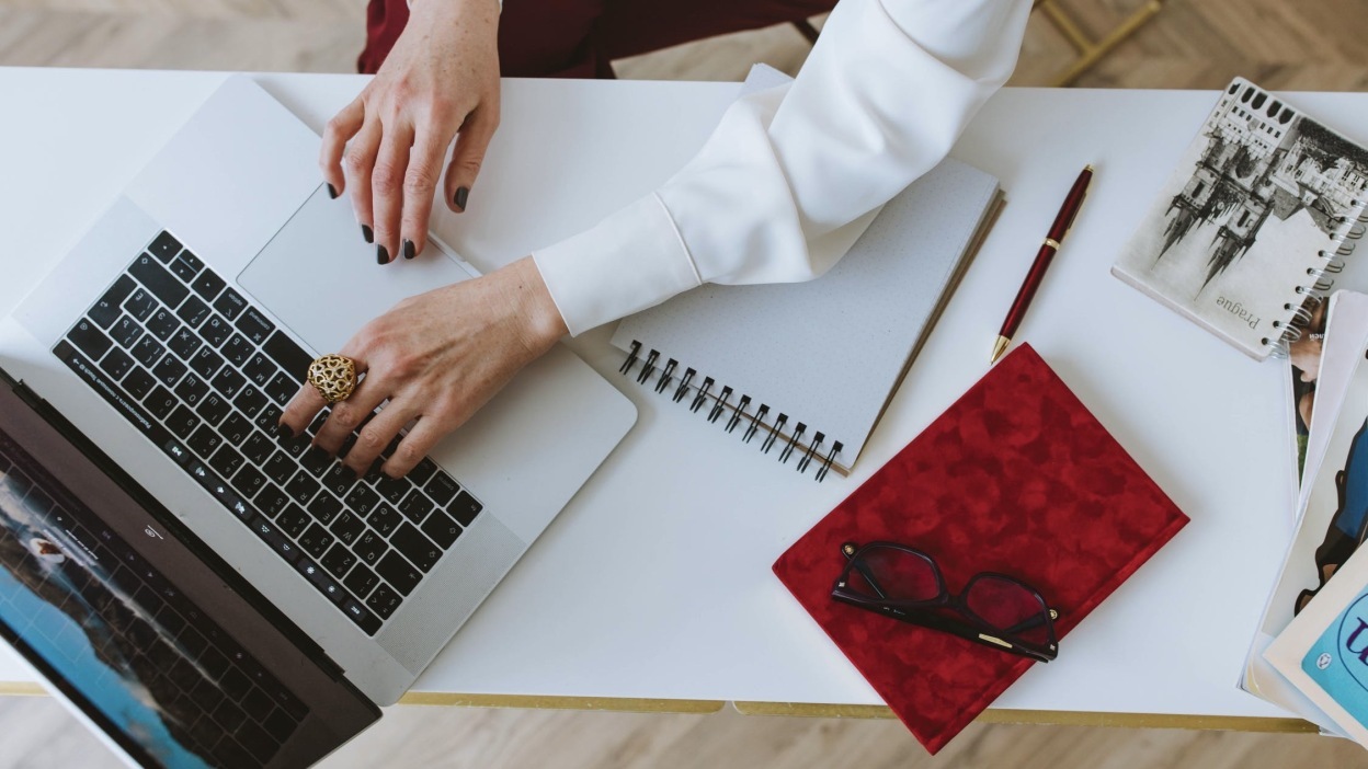 Laptop and book on table