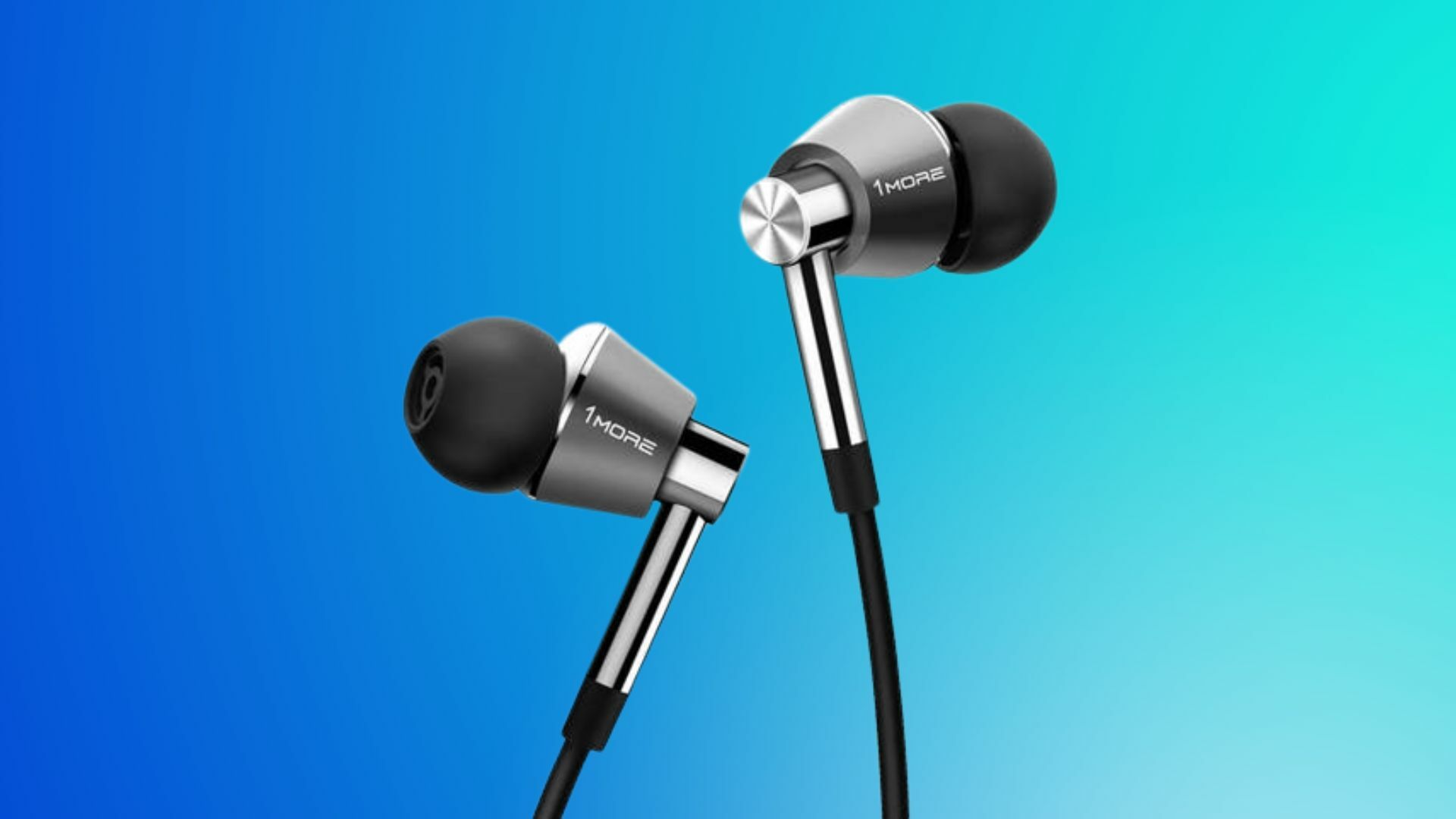 A pair of 1MORE Triple Driver In-Ear Headphones Silver on a blue background.