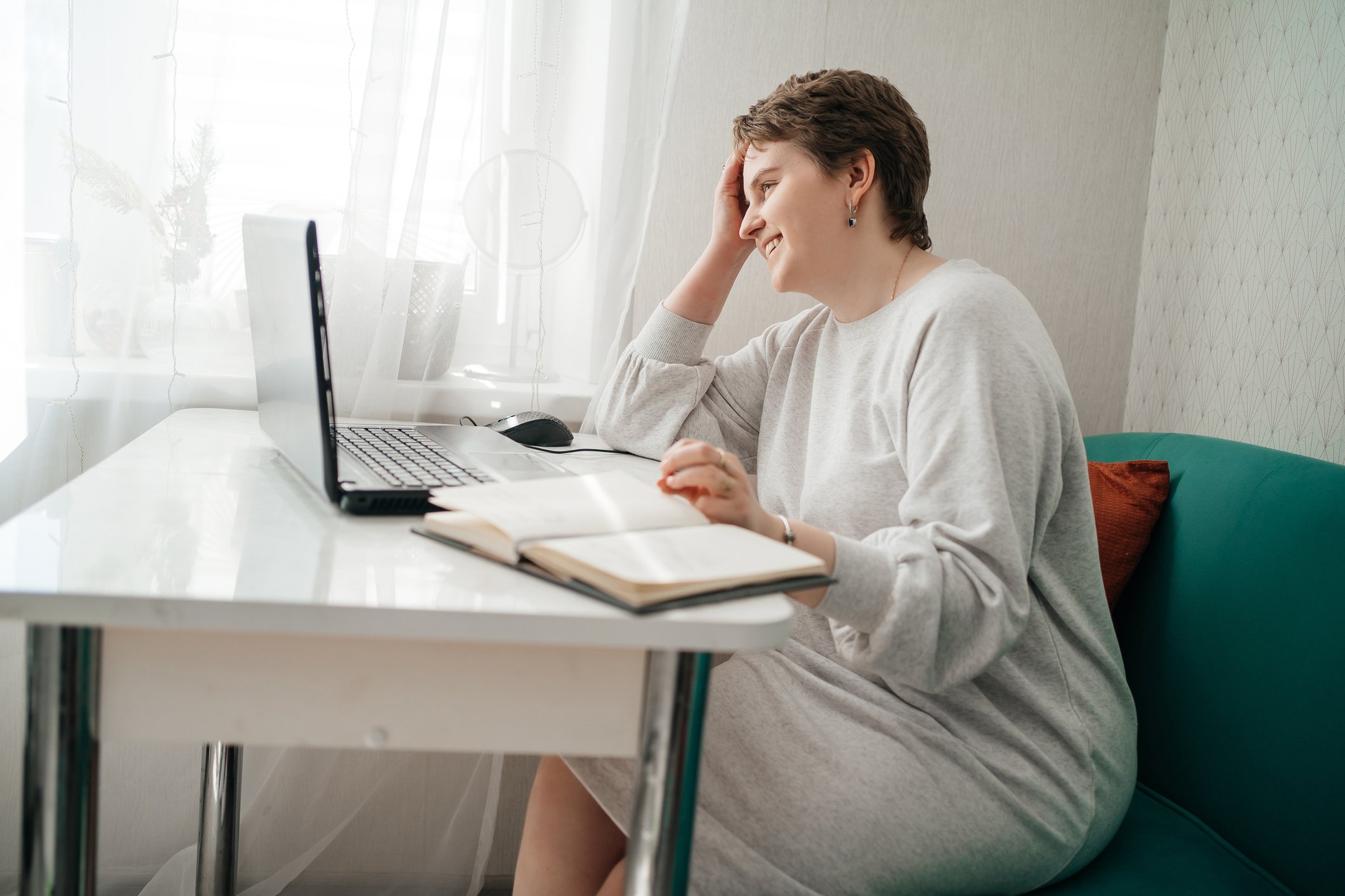 woman at kitchen table on laptop