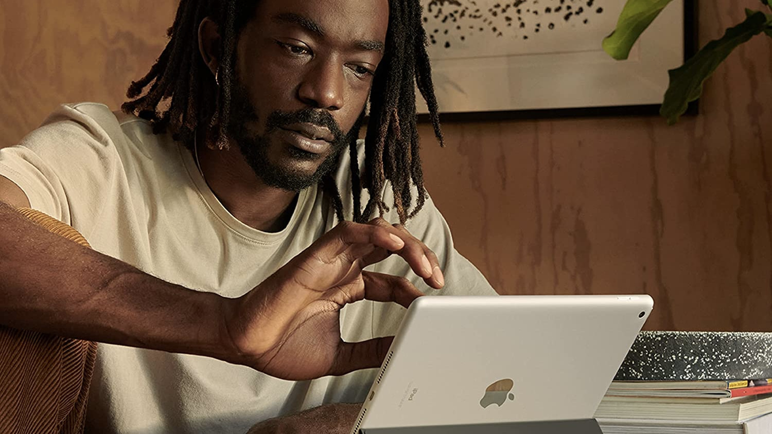 person sitting at table working on ipad