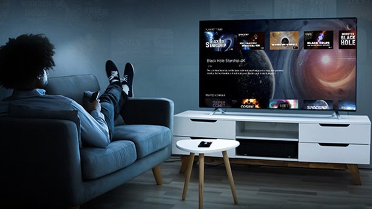 Person on a sofa watching MagellanTV.