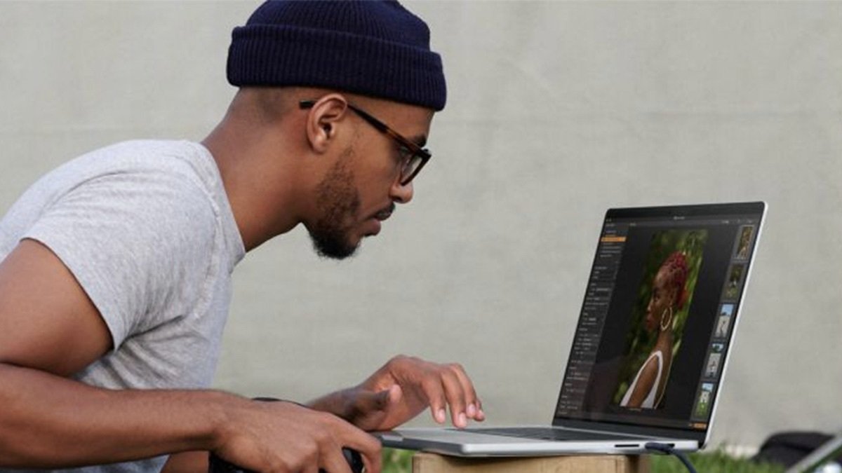 Person using the Apple 13.3-inch MacBook Air 128GB - Silver (Refurbished) to edit photos.