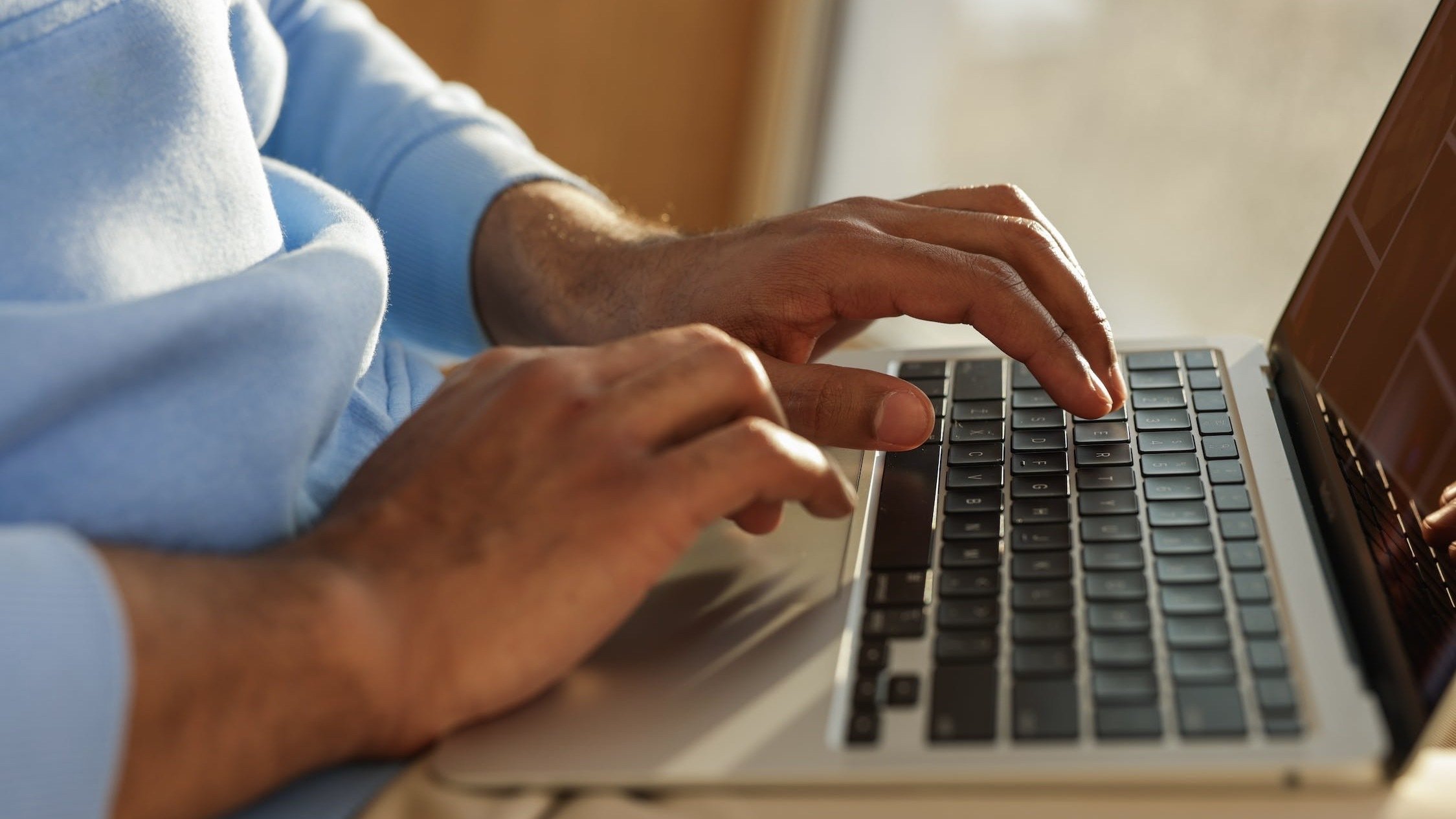 Person typing on laptop.