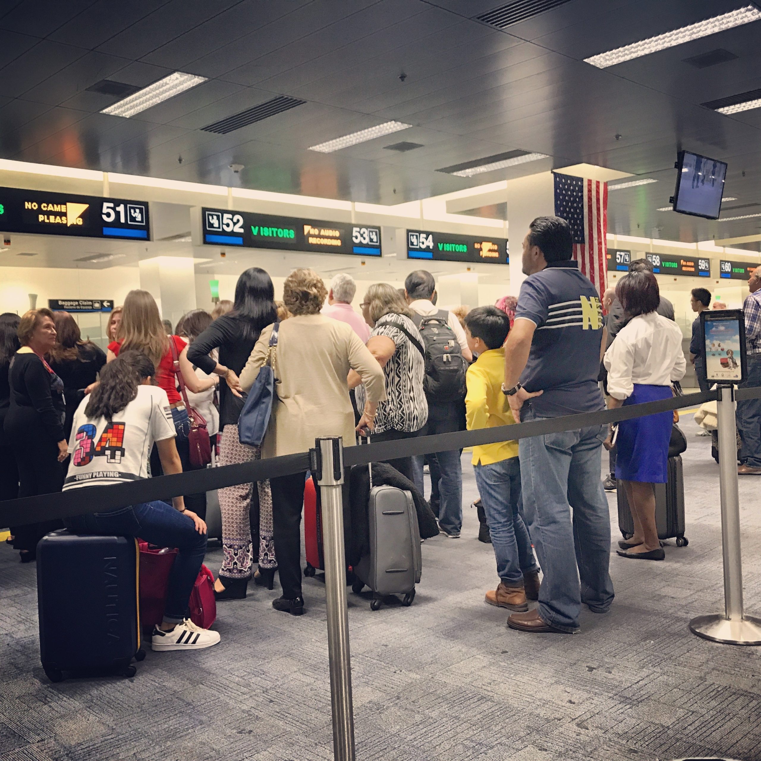 Queue of people waiting for Passport control in Miami Airport.