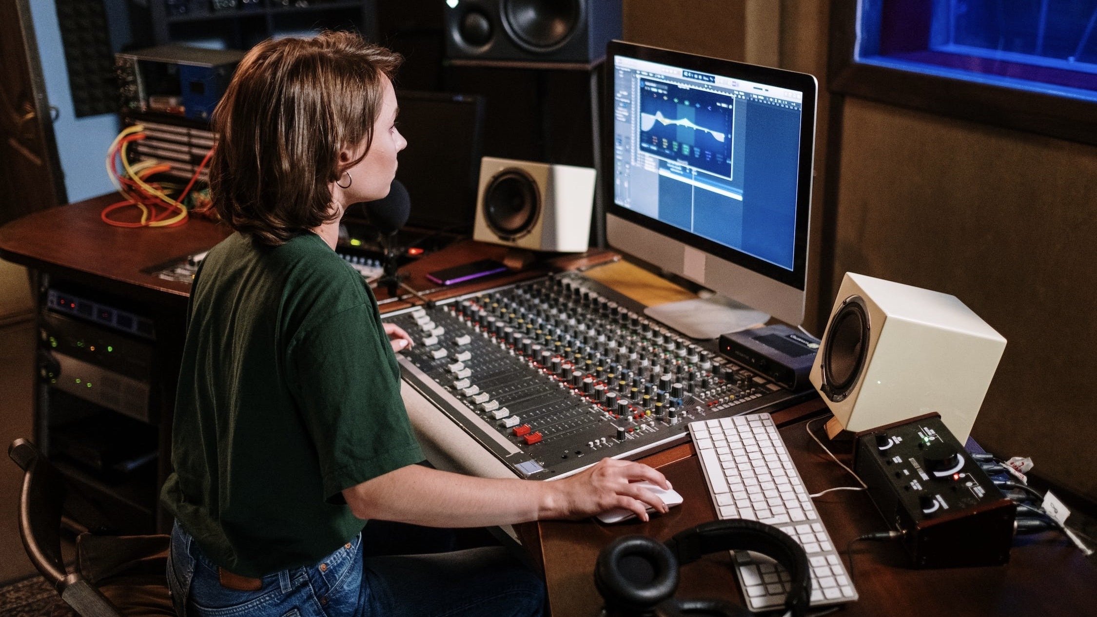 Person editing audio on a computer.
