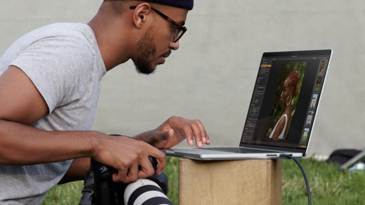 Person using the Refurbished 13.3-inch Apple MacBook Air to edit photos.