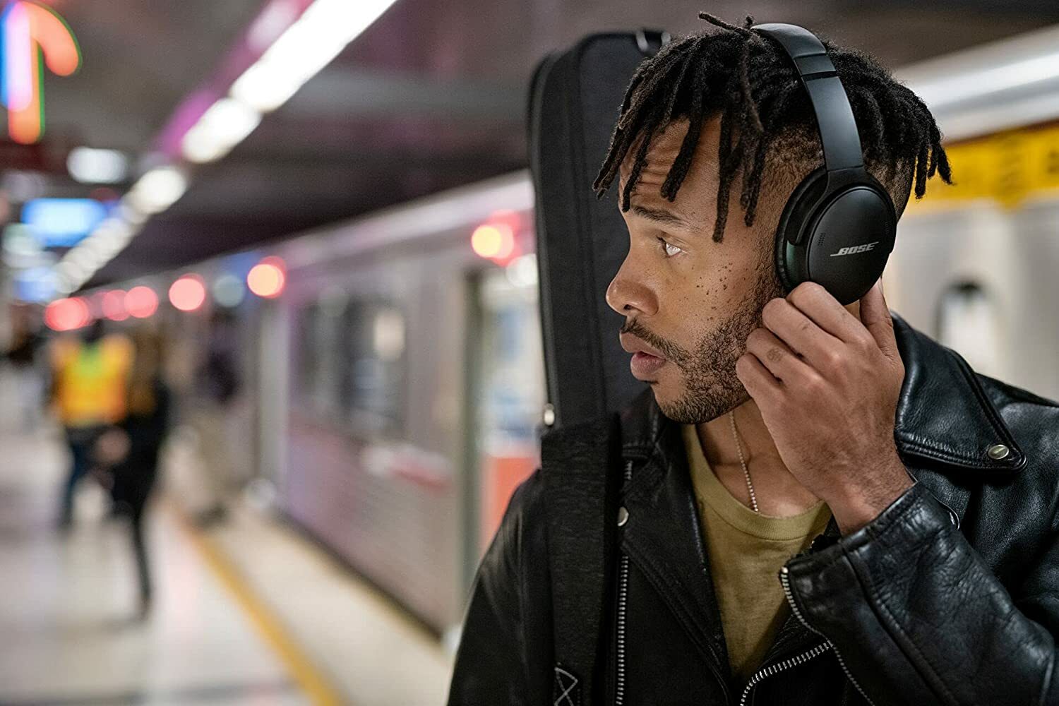 Man on the subway listening to Bose QuietComfort 45 wireless noise-canceling headphones