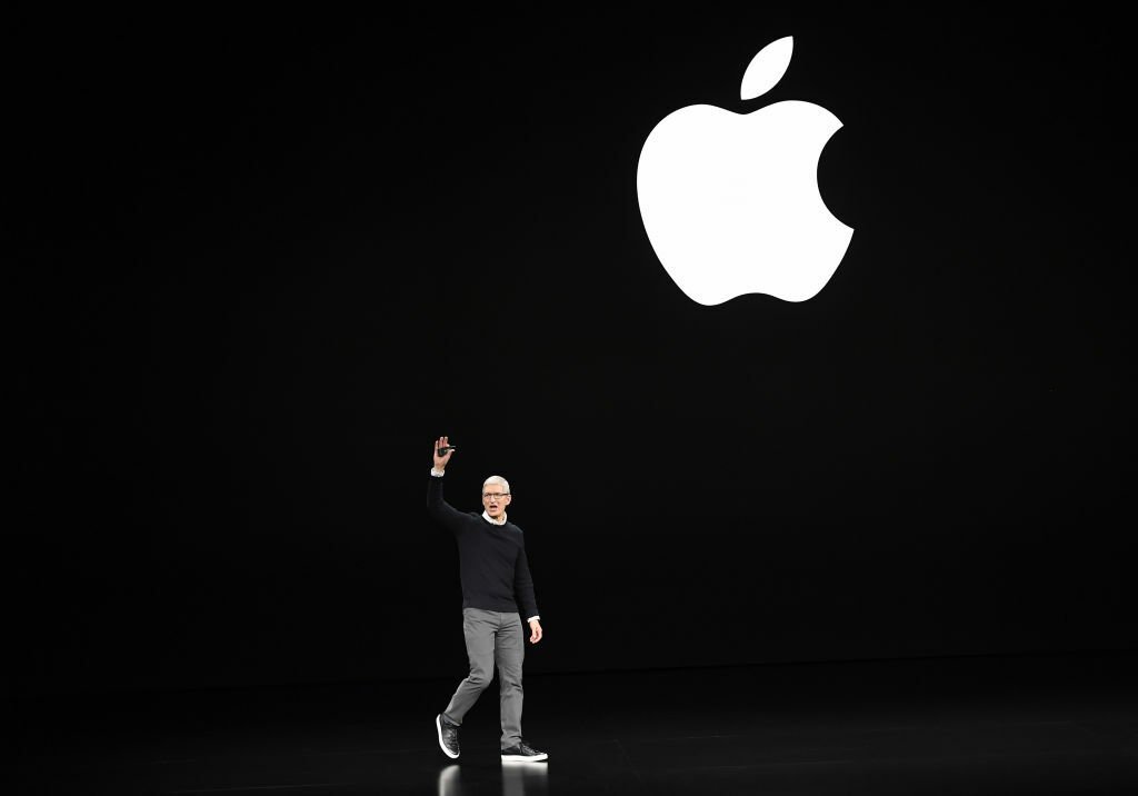 Tim Cook on stage in front of Apple logo