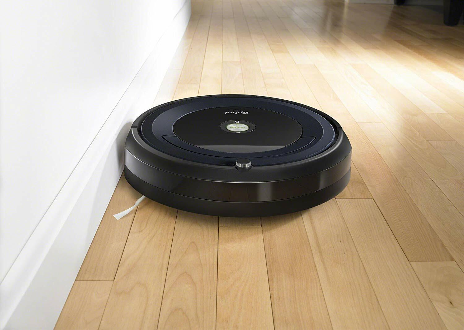 A robot vacuum cleaner on a hardwood floor