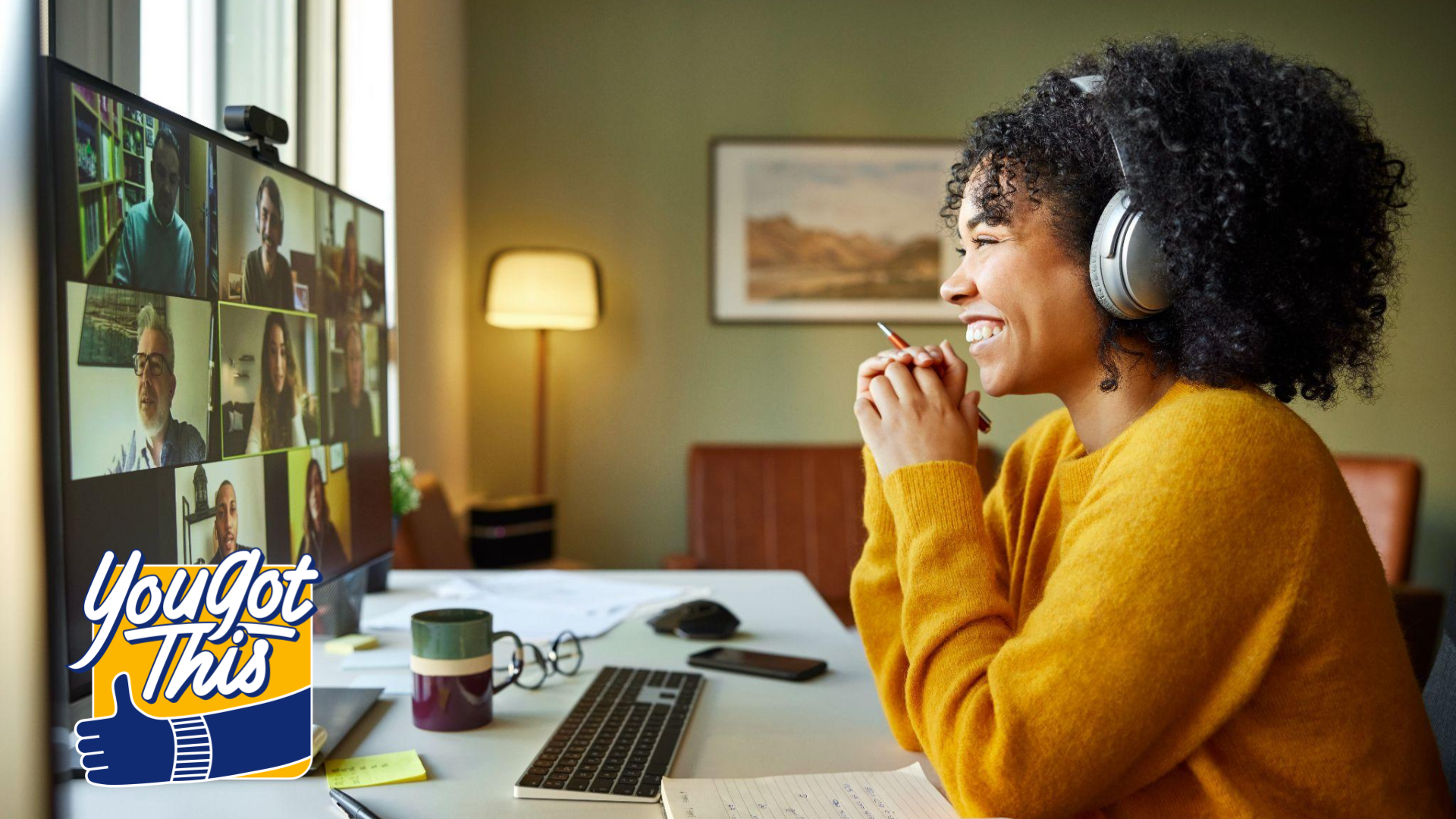 Young woman sitting at a desk, attending a video call.