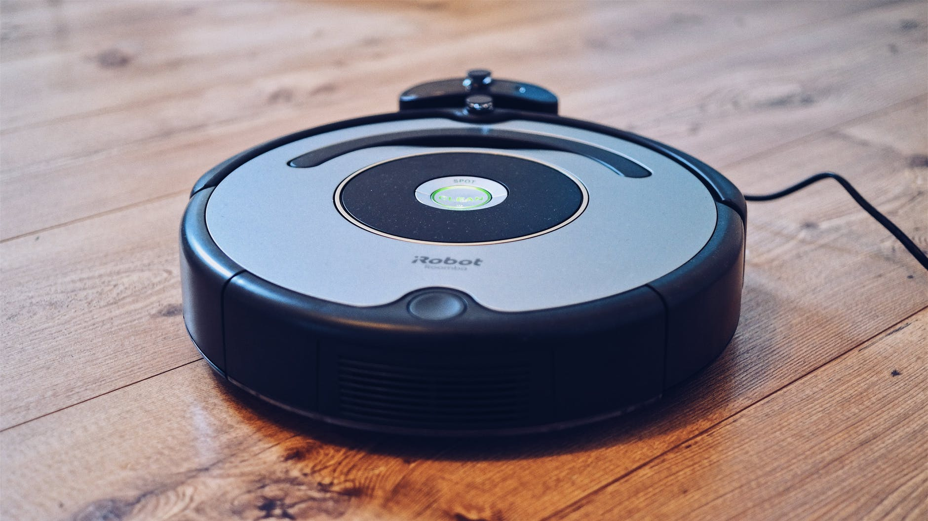 A robot vacuum n a hardwood floor