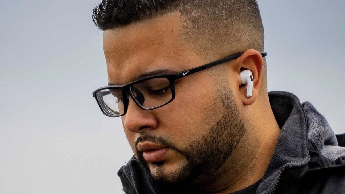 Person wearing a pair of TruPro 3 TWS Earbuds.