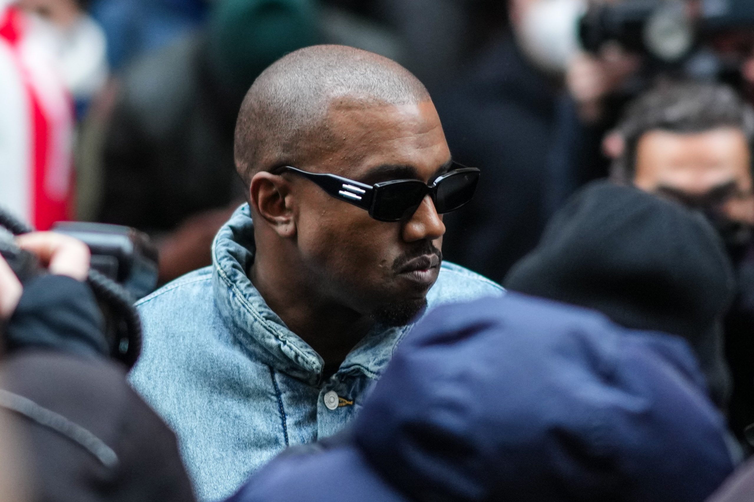 A photo of rapper Kanye West in a crowd at Paris Fashion Week.