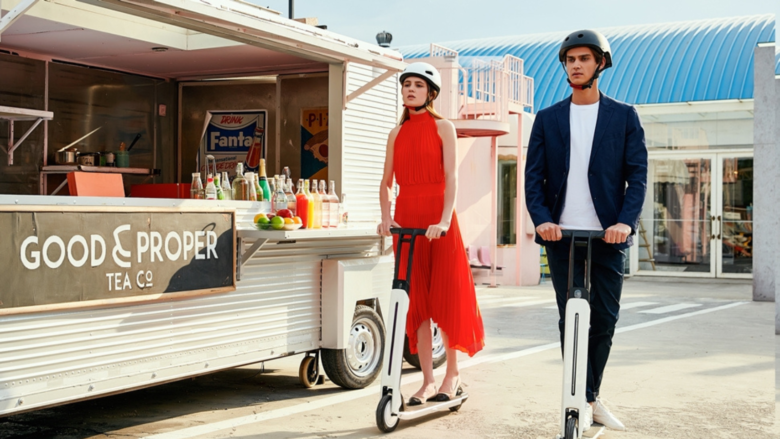 man and woman riding around city on segway ninebot electric scooters