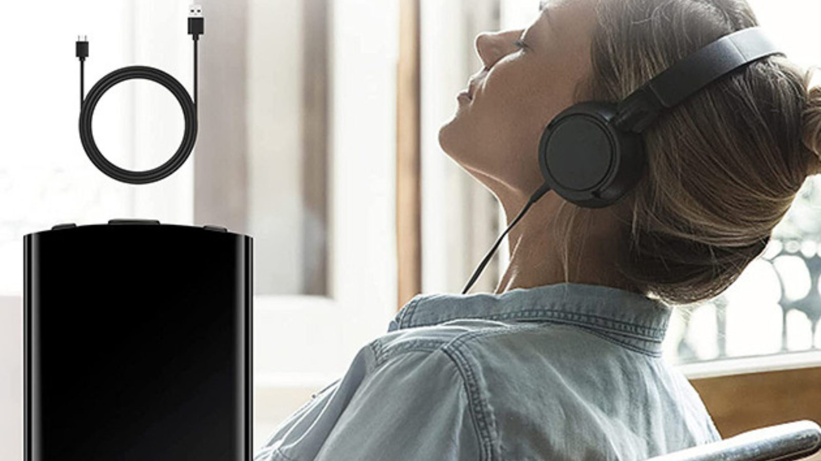 woman with headphones next to voice recorder and cable