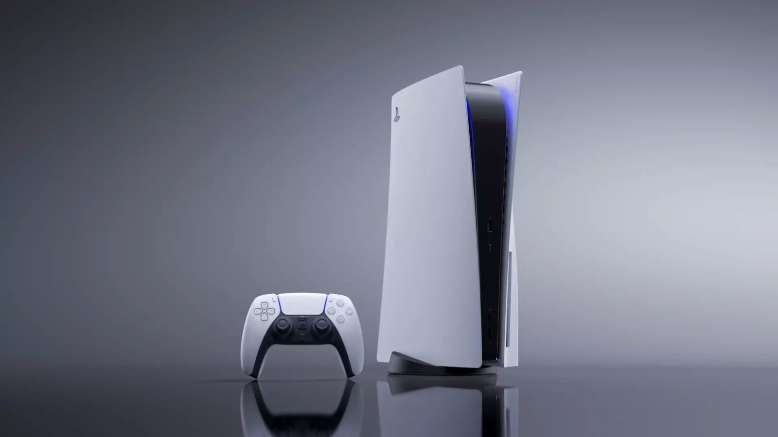 a playstation 5 next to the playstation dualsense wireless controller in a gray reflective space