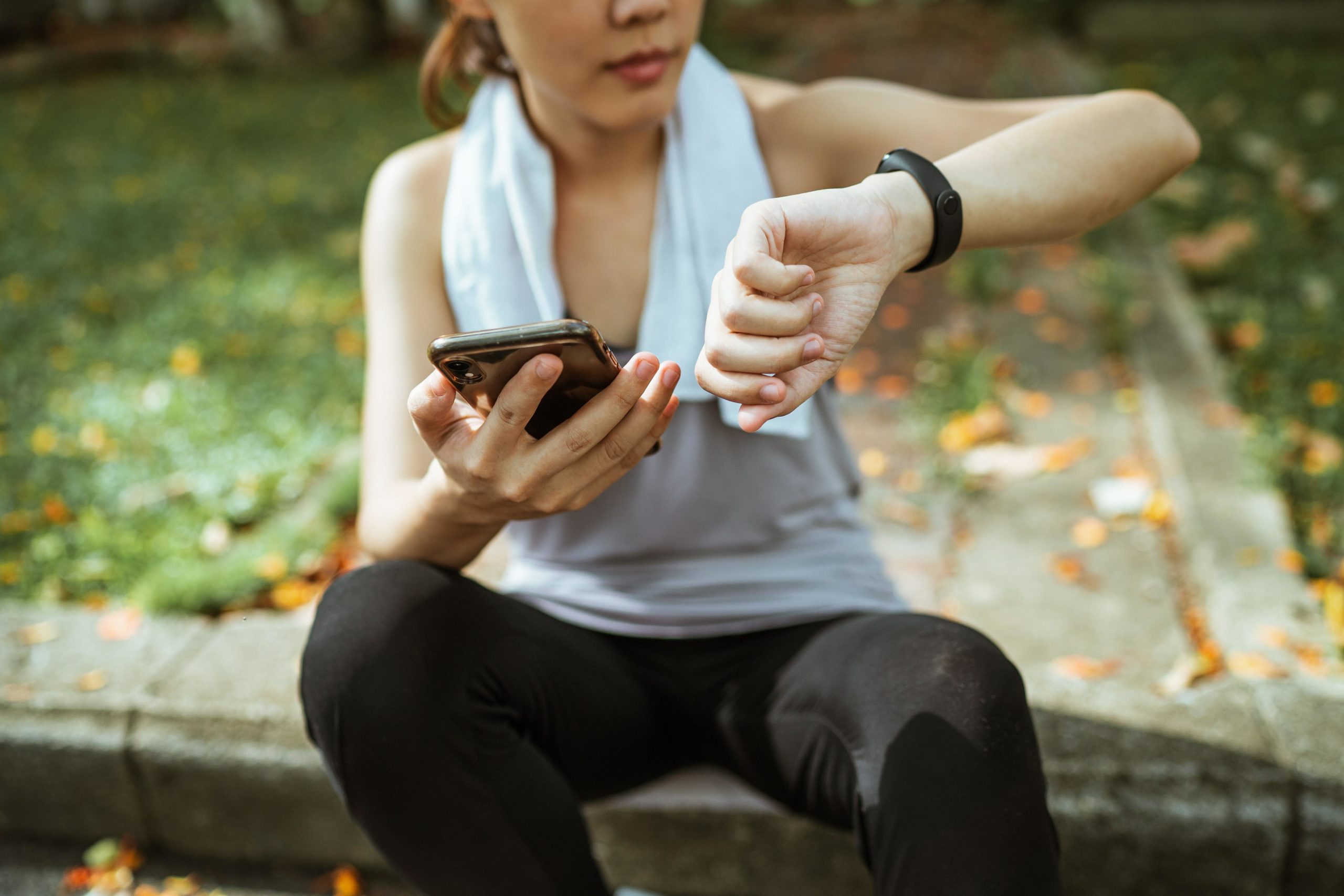 Girl looking at phone and smartwatch