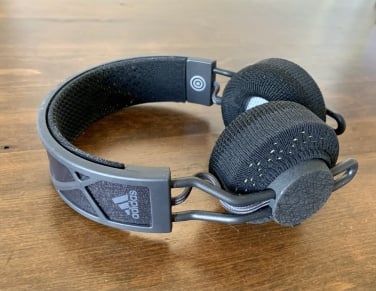 A shot of the headphones lying flat on a wooden table.