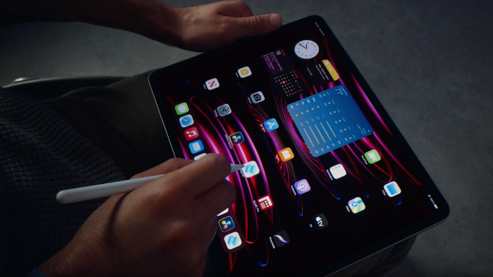 a close-up of man touching homescreen icons on an ipad pro using an apple pencil