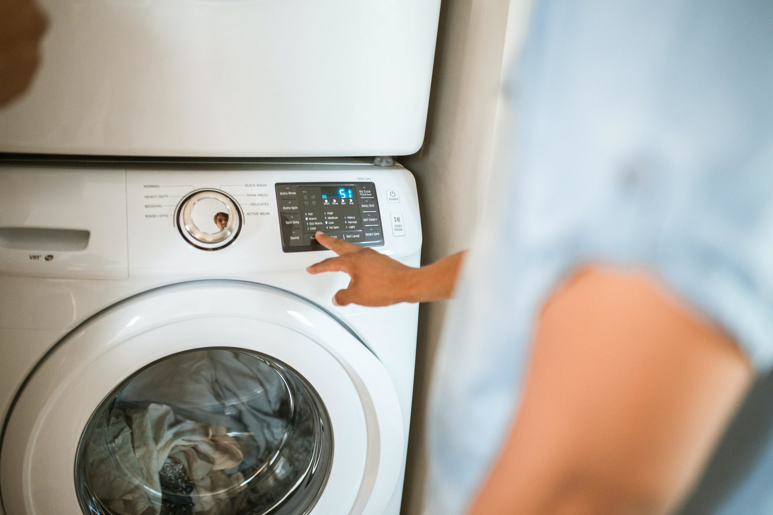 Man programming a washing machine