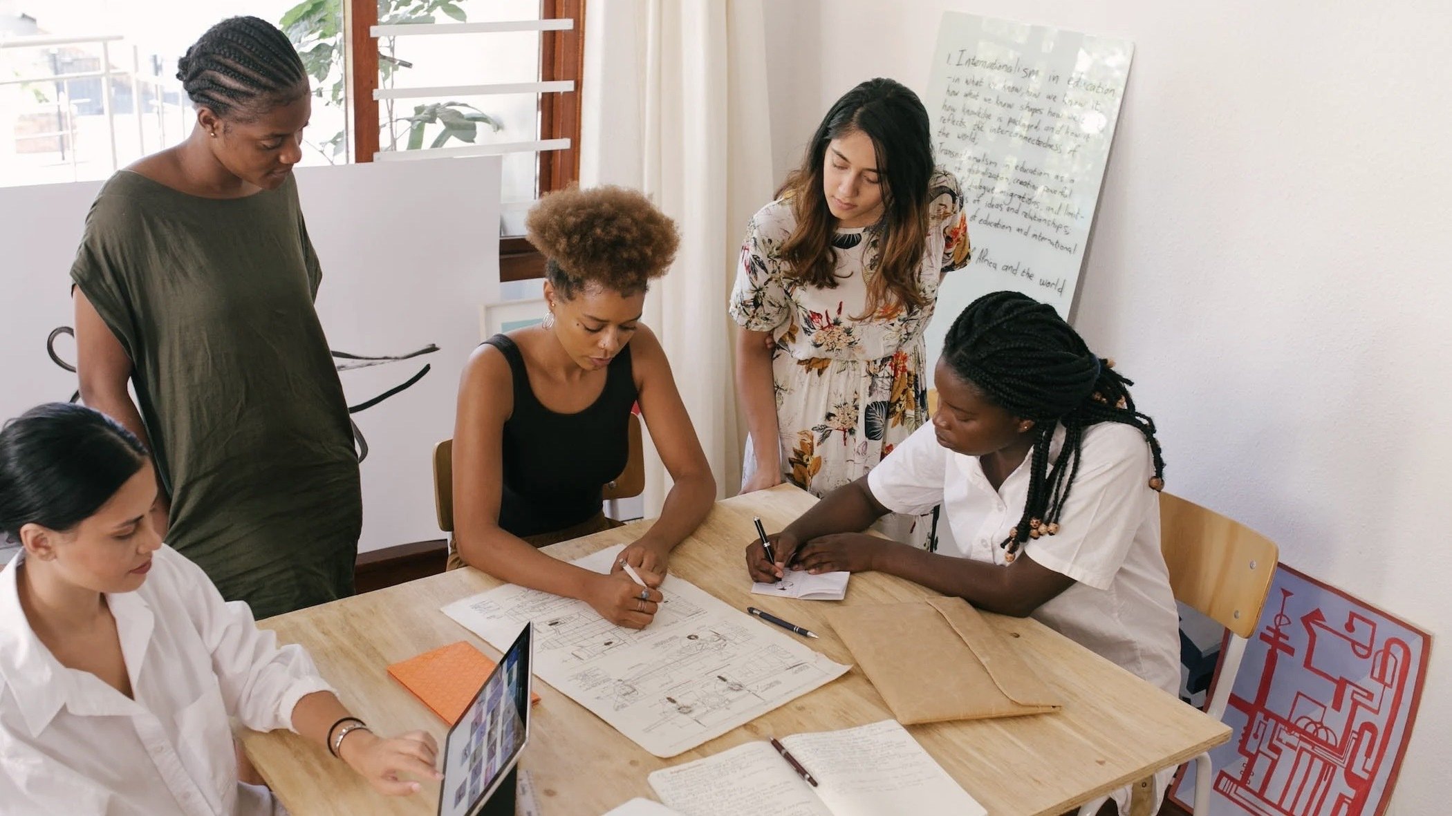 Group of people working together at a table.