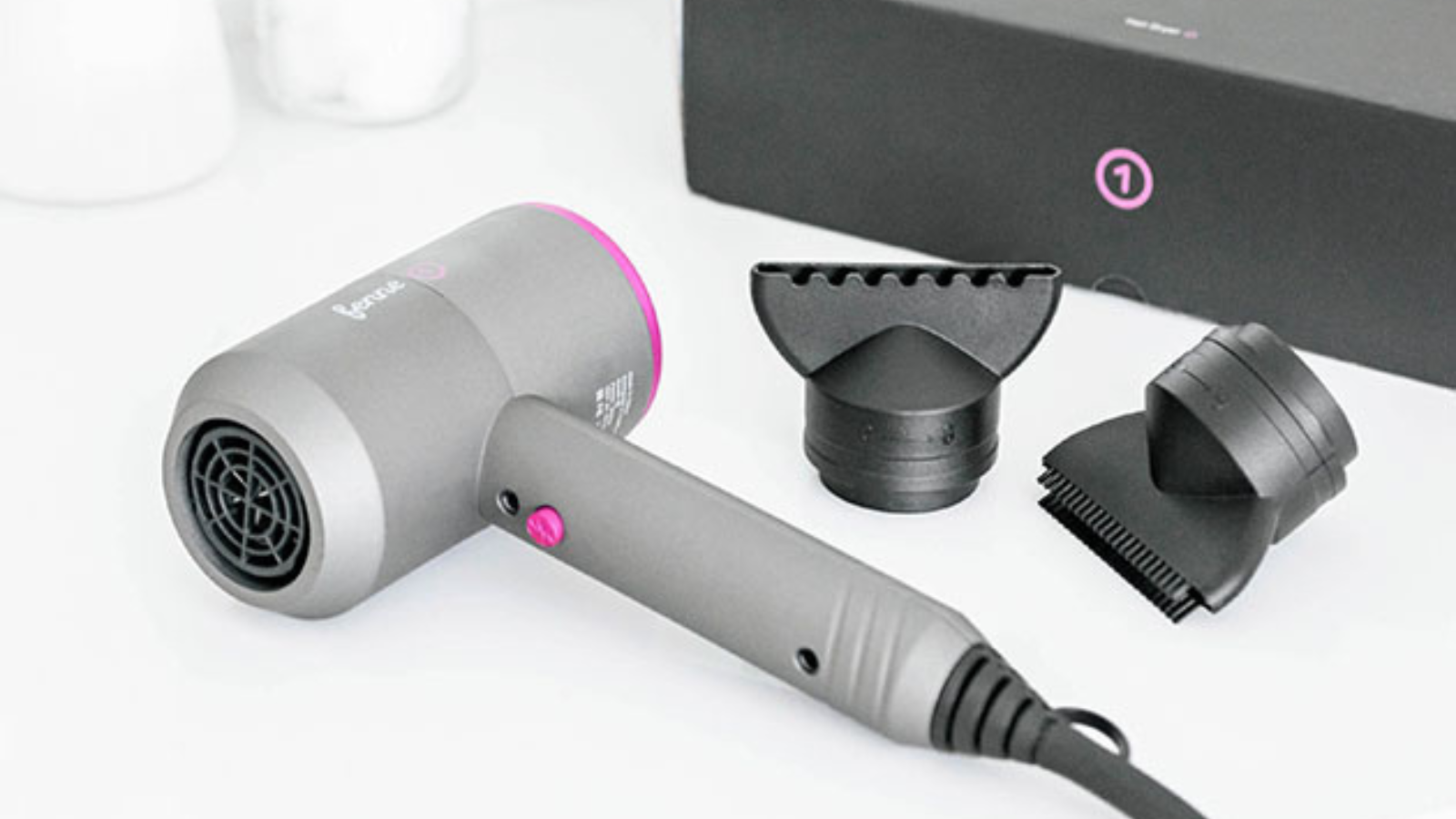 fenne hair dryer and attachments laying on counter