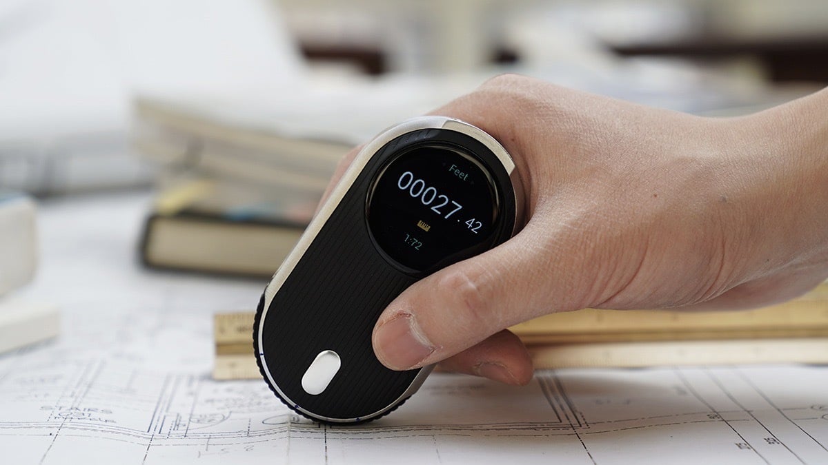 Person using the MEAZOR Six-in-One Digital Laser Measurement Tool.