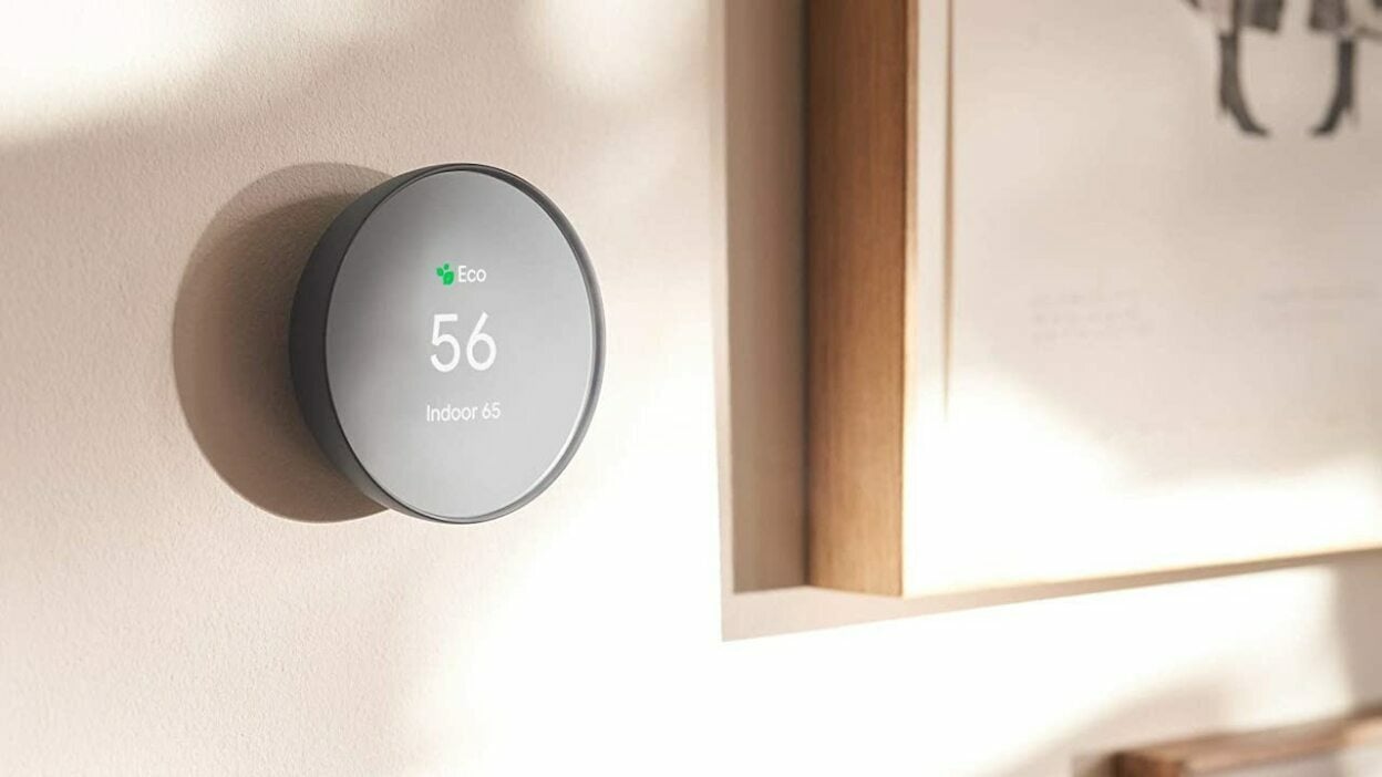 A circular thermostat has been placed on a wall