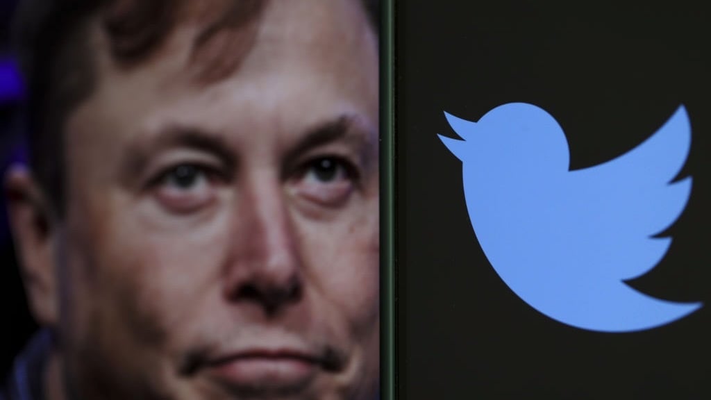 elon musk with twitter logo