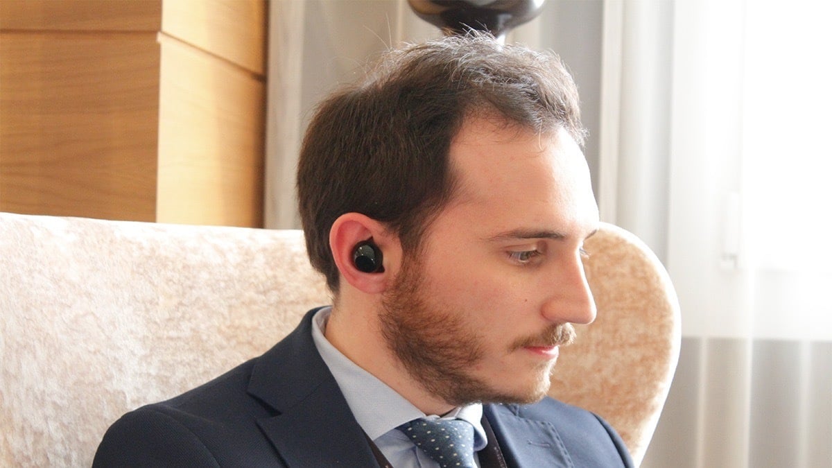 Person using the Mymanu CLIK S Translation Earbuds.