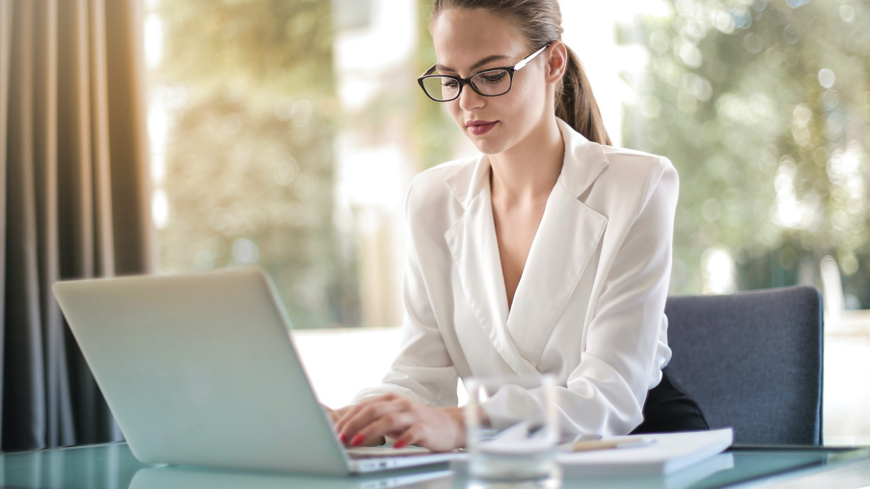 A woman is working on her aptop