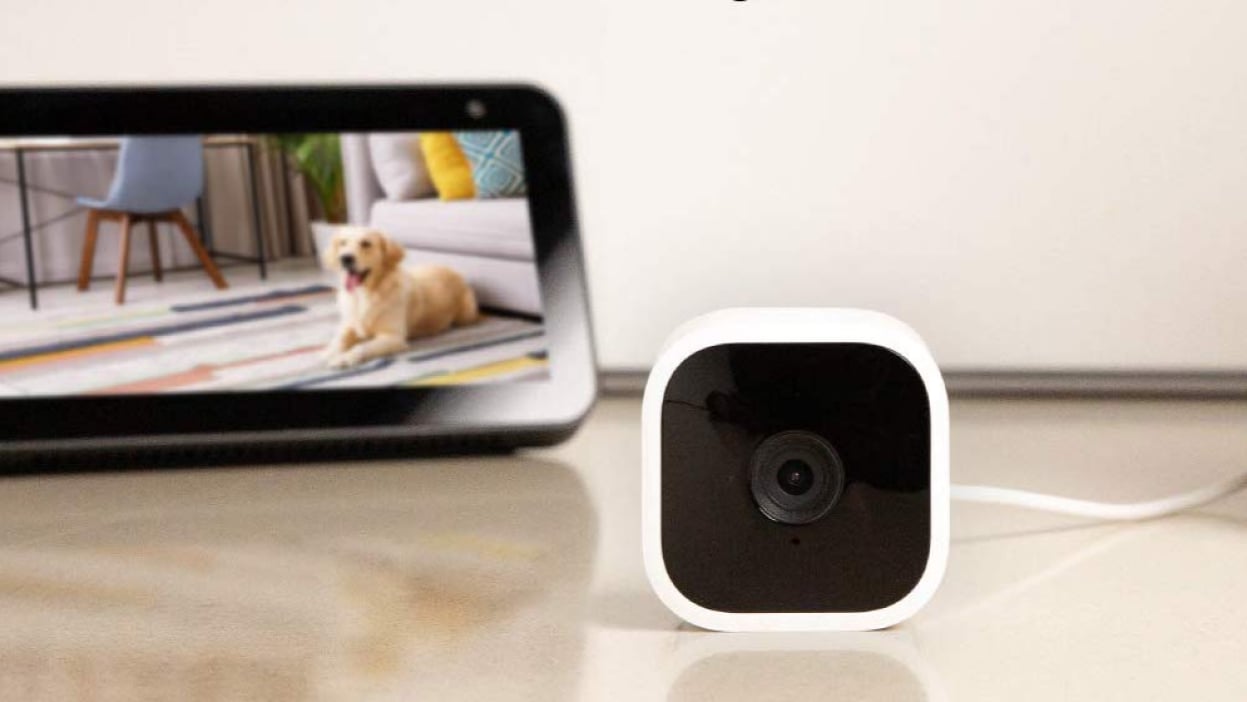 A white security camera is lying in a room