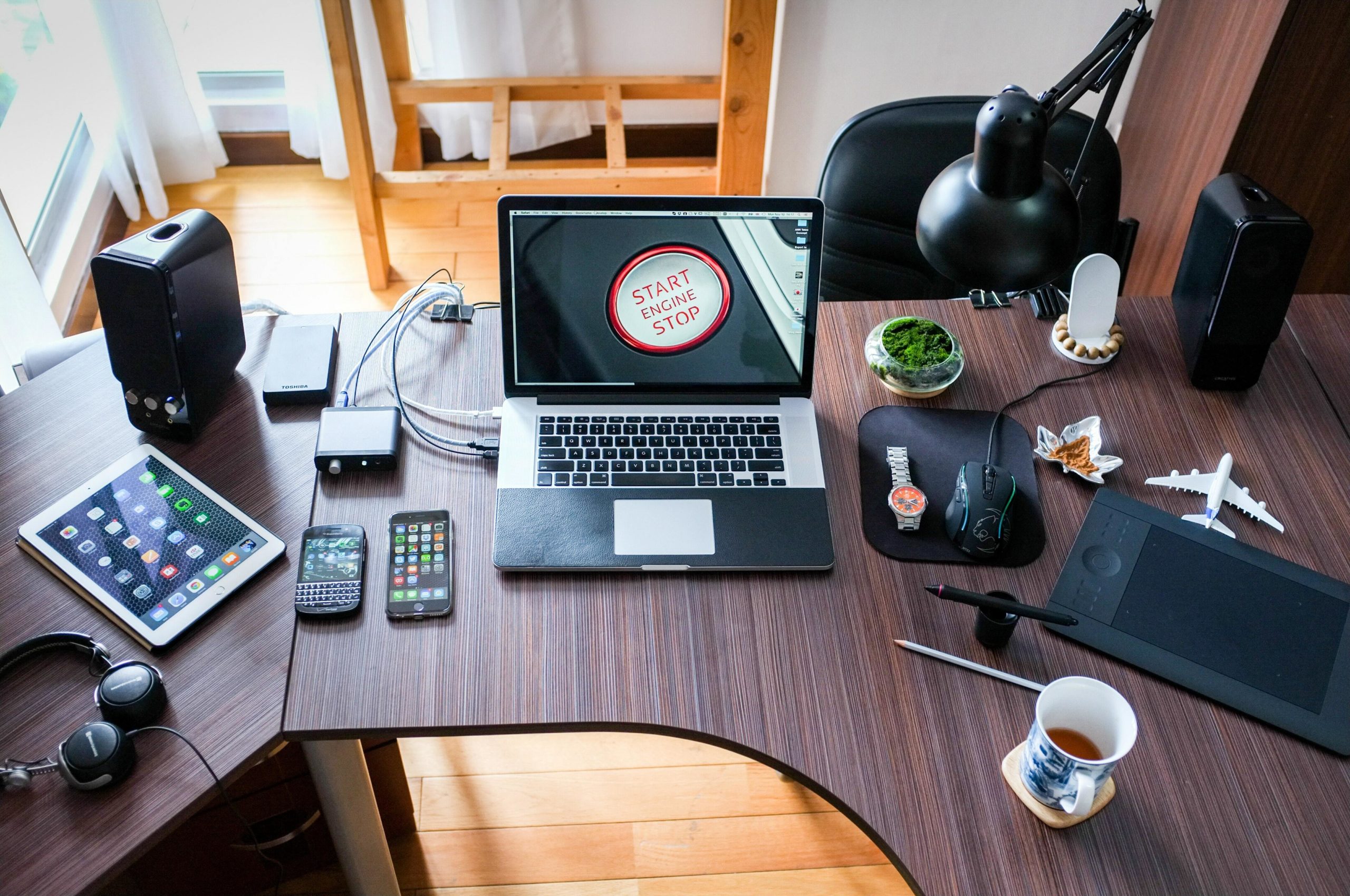 Laptop and many other devices on desk